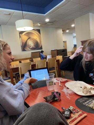 Students at Roswell, Lindsey Griffin and Lily Gruver, take up their extra time to study at Panera instead of doing other activities that need to be done. (Credits: Morandi Lawrence)