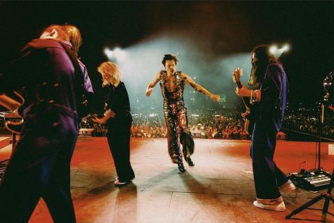 The first Coachella performance by Styles. He dances on stage with his band wearing a rainbow sequin jumpsuit.