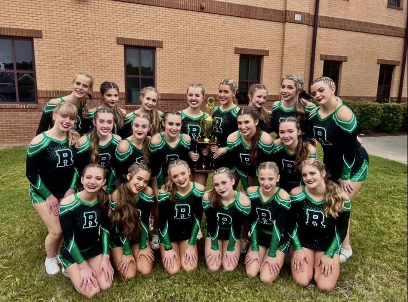 The+varsity+cheer+team+at+their+first+competition.+Front+row%2C+fourth+person+from+left+in+is+Katelyn+Willis%2C+fifth+from+left+is+Romy+Teat.+In+the+back+row%2C+sixth+from+left+is+Nayland+Ryczek.+%28Credit%3A+Caroline+Manus%29