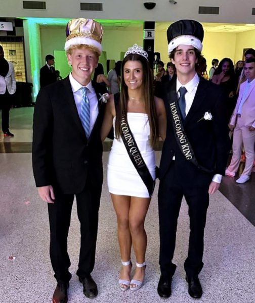 Senior Carolina Jenacova and Senior Walker Routt standing proudly after being announced homecoming King and Queen. Alongside them stands Junior Henry Hampel who participated in the homecoming court. 
