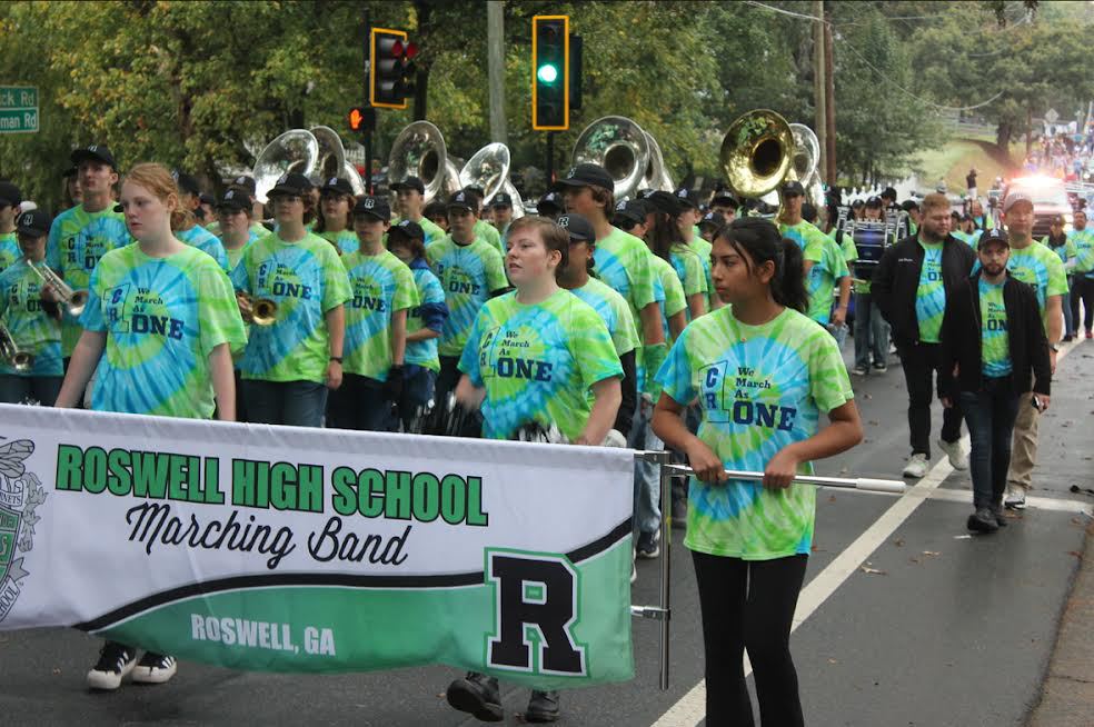Roswell+Marching+Band+leading+with+Centennial+Marching+band+as+they+get+the+crowd+excited+by+playing+upbeat+music.