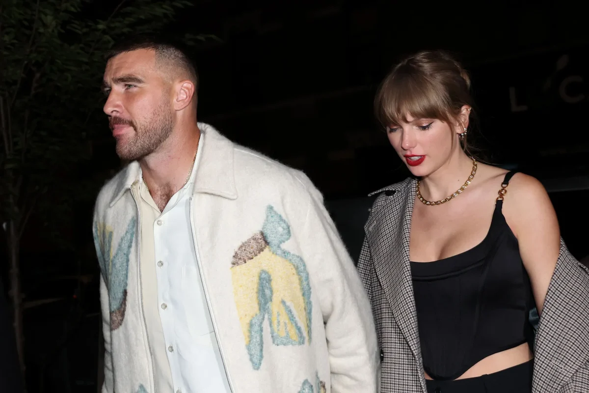 Taylor and Travis out together surrounded by all the paparazzi. This night went viral on social media as it seems Travis has red lips supposedly from Taylors classic red lip look. This was one of their first sightings in public together. (Credit: Johnny Nunez/ Getty Images)