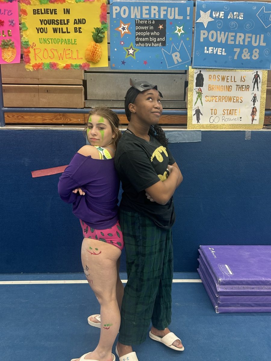Emelyn loves gymnastics and all the fun practices they get to partake in. Here she is posing with sophomore Nagna Diobate during a Halloween themed practice.