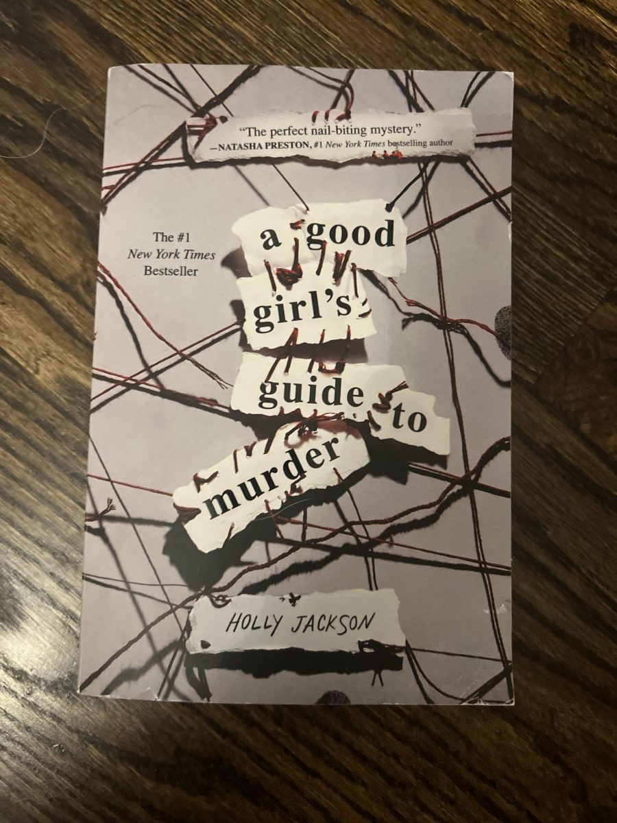 Goodreads Choice Award Nominee for Young Adult Fiction “A Good Girl’s Guide to Murder” lies on top of hardwood floor. (Credit: Karlie Zabrocki)