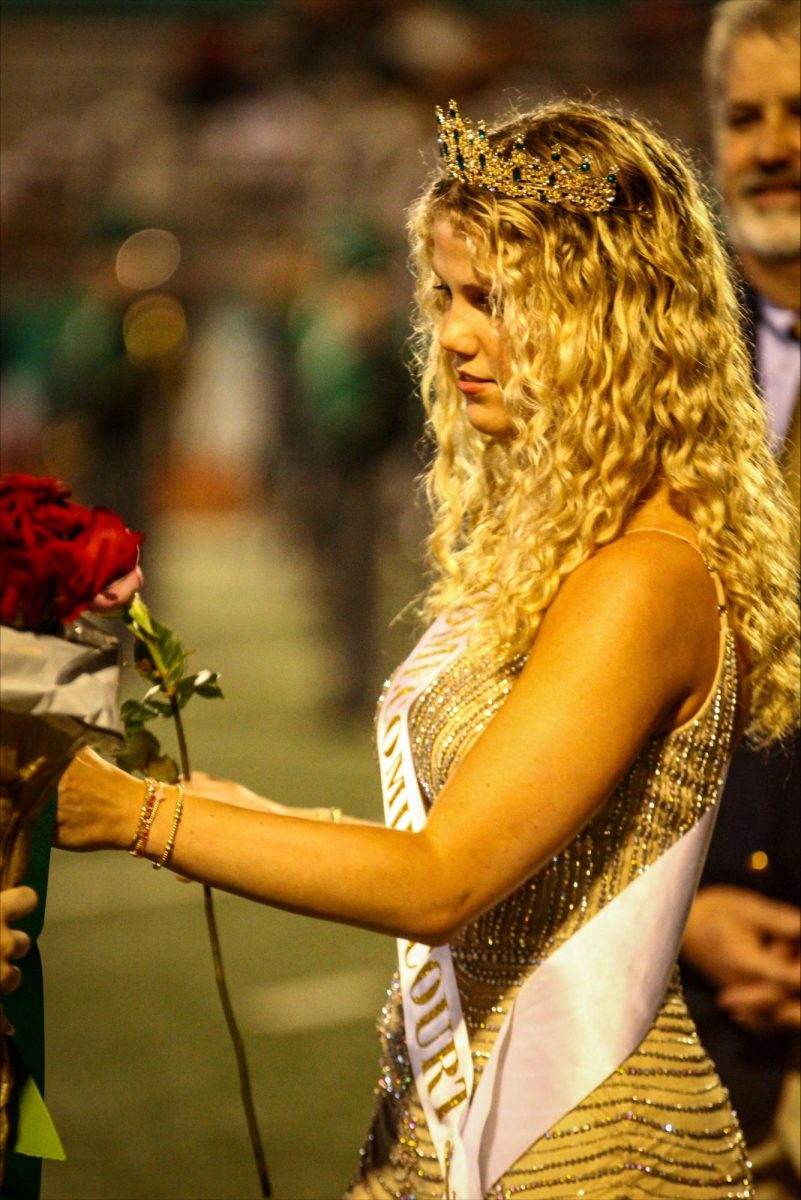 Caroline Head (12) is accepting her crown for Homecoming Queen after being announced the winner at halftime during the football game.                                              