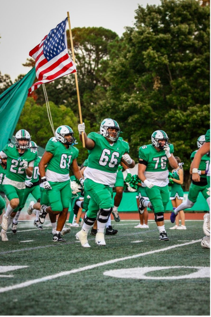 The football team running out of the tunnel ahead of the week five matchup against the Seckinger Jaguars on Sep. 20, 2024, with Senior guard Kevin Guardado (66) leading the way. 