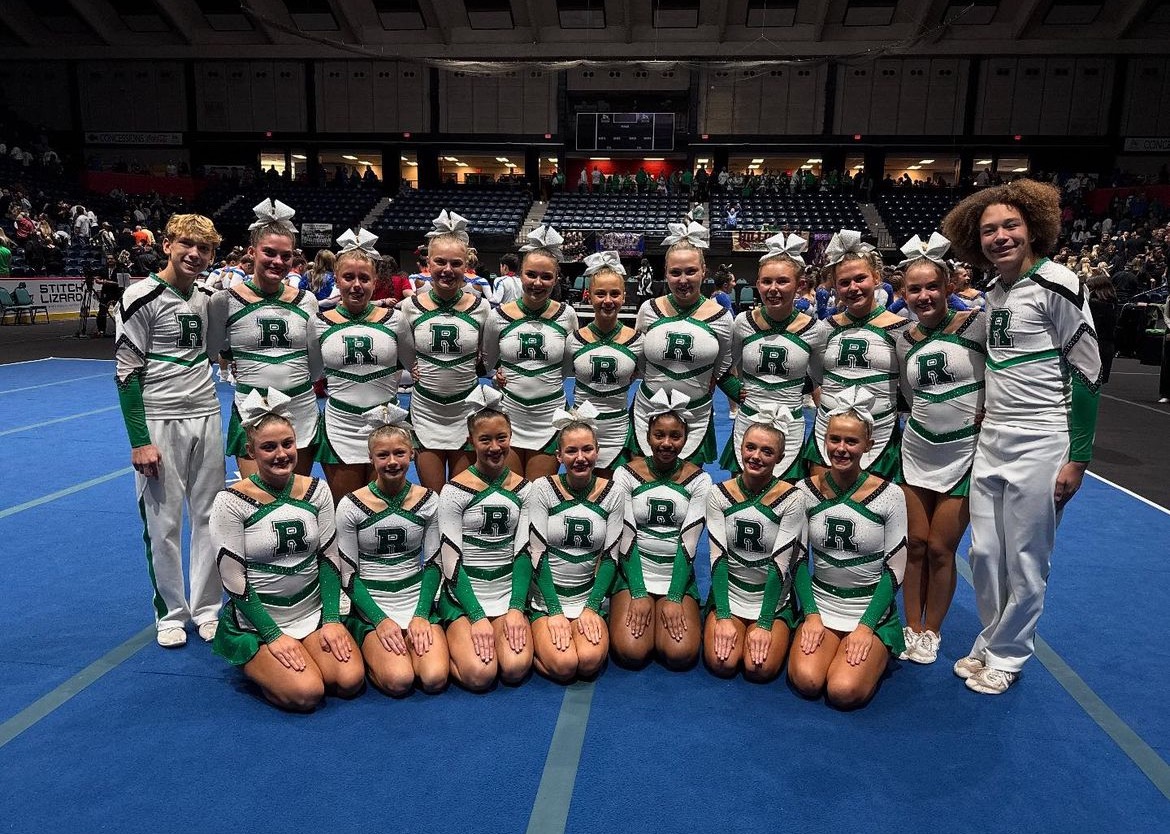 Roswell Hornet Cheerleaders are coming together to take a team photo before the team’s performance at State. 