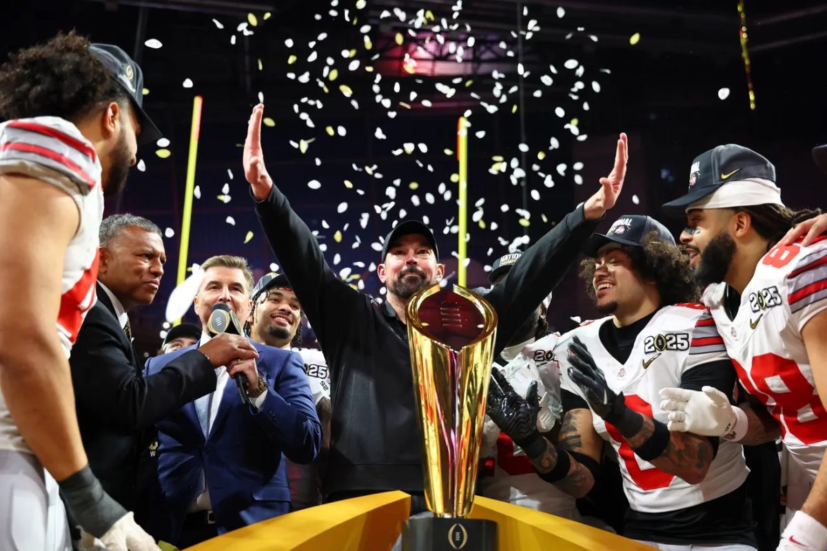 Head Ohio State coach Ryan Day celebrating after the big win with the famous trophy.