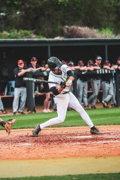 Senior Hiram Zamora batting against the Lassiter Trojans in the first game of the playoff series on April 23, 2025, at John P. Coen Sr. Field.