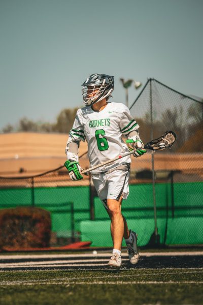 Junior Kaden Parla looking to pass against Trinity High School on Mar. 22, 2025.