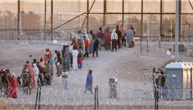 At the U.S Mexico Border, Immigrants stand in line waiting to be processed by the U.S Border Patrol officers. This took place on May 12, 2023, in El Paso, Texas. 